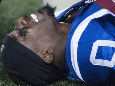 The Alouettes' Stefan Logan grimaces in pain from an apparent leg injury after he was tackled by Redblacks players late in the fourth quarter of play in Montreal on Friday night.