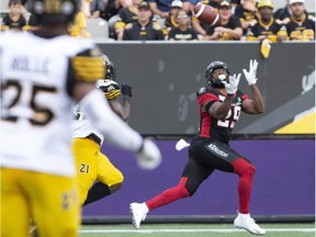 Ottawa Redblacks William Powell makes a catch while being defended by Hamilton Tiger-Cats linebacker Simoni Lawrence (21) during second half CFL football game action in Hamilton, Ont. on Saturday, July 28, 2018.