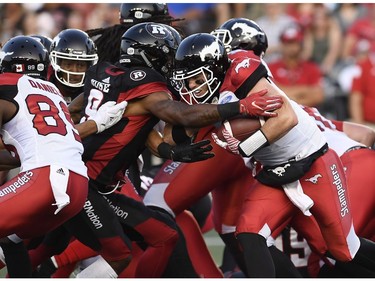 Calgary Stampeders quarterback Nick Arbuckle (9) tries to make his way past Ottawa Redblacks Jonathan Rose (9) during first half CFL action in Ottawa on Thursday, July 12, 2018.