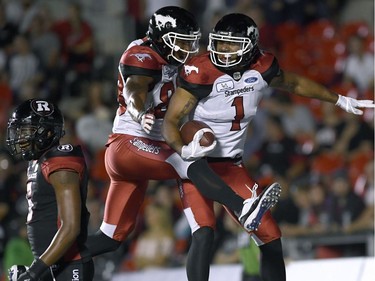 Calgary Stampeders Lemar Durant (1) celebrates his touchdown with Kamar Jorden (88) as Ottawa Redblacks Loucheiz Purifoy (5) walks off, during second half CFL action in Ottawa on Thursday, July 12, 2018.
