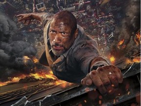 This image released by Universal Pictures shows Dwayne Johnson in a scene from "Skyscraper." (Universal Pictures via AP)