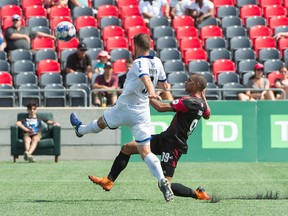Kyle Venter of Penn FC, left, plays the ball away from Tony Taylor of Ottawa Fury FC during a USL match at TD Place stadium yesterday. Ottawa won 2-1. (Steve Kingsman/Freestyle Photography for Ottawa Fury FC)
