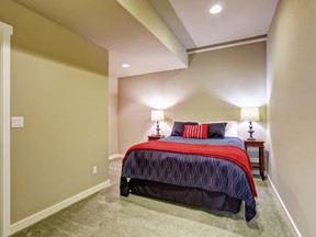 Basement guest bedroom with blue and red bed