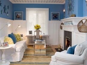 AFTER: Painted wall paneling, a fresh new colour scheme and the updated fireplace all help to create a fresh new look.