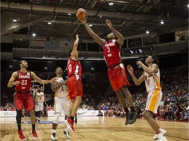 Canada's Melvin Ejim (3) pulls down a rebound in the firs quarter of Monday's game against U.S. Virgin Islands. Errol McGihon/Postmedia