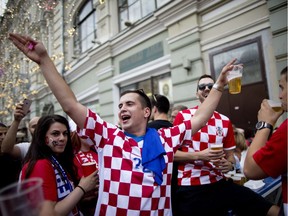 Croatian fans cheer on Nikolskaya Street, near Red Square in Moscow, on Saturday, one day before their national soccer team faces France in the World Cup final.
