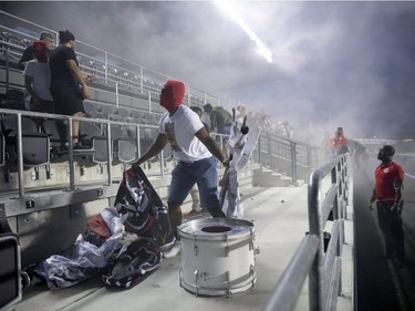 Toronto FC fans are ejected from the stadium after a flare was thrown onto the field during second half Canadian Championship soccer action between the Ottawa Fury FC and the Toronto FC, in Ottawa on Wednesday, July 18, 2018.