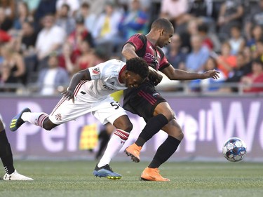 Toronto FC's Malik Johnson (56) battles with Ottawa Fury FC's Tony Taylor (99) during first half Canadian Championship soccer action in Ottawa on Wednesday, July 18, 2018.