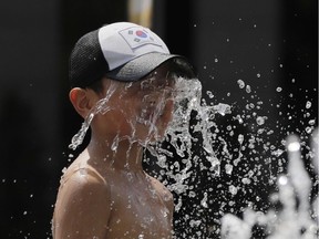 A boy cools himself off.