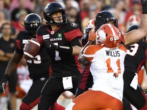 Redblacks quarterback Trevor Harris (7) looks up the field as Lions' Odell Willis (11) tries to make his way towards him, during first half CFL action in Ottawa on Friday, July 20, 2018.