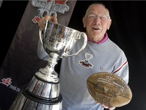 Russ Jackson holds the game ball of the 1909 Grey Cup.