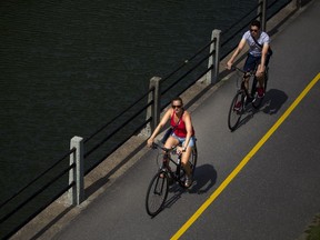 Hot, humid conditions didn't stop people from getting outside in Ottawa on Saturday. Here some unidentified cyclists enjoyed a ride along the Rideau Canal.   Ashley Fraser/Postmedia
