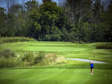 Lana MacKenzie drives the ball down the fairway during Saturday's round at The Marshes.  Ashley Fraser/Postmedia