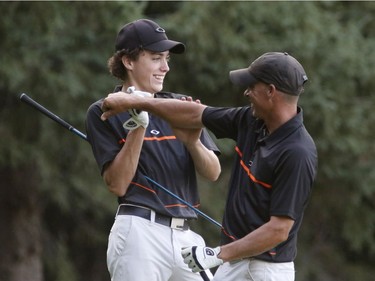 Hunter McGee, left, and his father, Allen McGee, celebrate a successful shot during Sunday's final round of the Ottawa Sun Scramble at Eagle Creek. Patrick Doyle/Postmedia