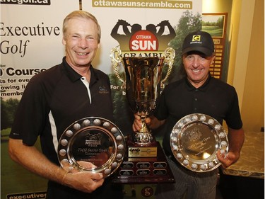 Stan Hogan, left, and Graham Gunn show off the winners' trophies from the TMSI Senior Open Division of the Ottawa Sun Scramble after Sunday's final round at Eagle Creek. Patrick Doyle/Postmedia