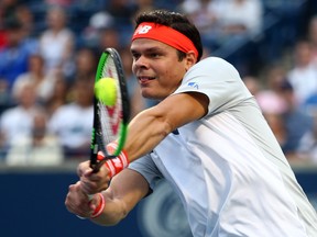 Milos Raonic returns a shots against David Goffin of Belgium during first-round play at the Rogers Cup at Aviva Centre in Toronto yesterday.  Vaughn Ridley/Getty Images