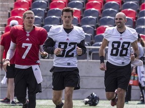 Brad Sinopoli (88) jogs beside Redblacks quarterback Trevor Harris (7) and fellow receiver Greg Ellingson during a practice at TD Place stadium earlier this week. Errol McGihon/Postmedia