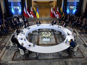 Georgian President Giorgi Margvelashvili (4R), Polish Foreign Minister Jacek Czaputowicz (3L), Lithuania's Foreign Minister Linas Linkevicius (L), Latvia's Foreign Minister Edgars Rinkevics (2L) and other officials attend a round table meeting in Tbilisi on August 7, 2018, a day ahead of the 10th anniversary of the start of the brief war between Russia and Georgia over control of South Ossetia. (Vano Shlamov/Getty Images)