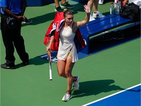 Simona Halep of Romania waves to the crowd as she leaves the court after losing to Kaia Kanepi of Estonia during the first round of women's singles at the U.S. Open tennis championship in New York on Monday.