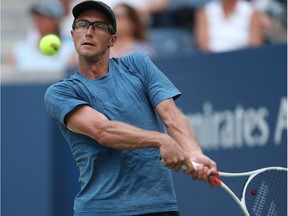 Peter Polansky hits a return to Alexander Zverev during their U.S. Open first-round men's singles match at New York on Tuesday.