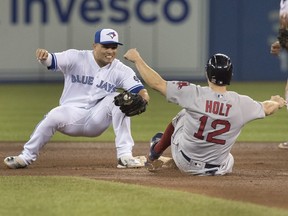 Boston Red Sox' Brock Holt is out stealing second as Toronto Blue Jays' Aledmys Diaz stretches with the tag in the fifth inning of their American League MLB baseball game in Toronto on Thursday, August 9, 2018.