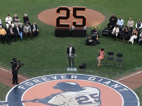 Former San Francisco Giants player Barry Bonds, centre, speaks during a ceremony to retire his jersey number before a baseball game between the Giants and the Pittsburgh Pirates in San Francisco, Saturday, Aug. 11, 2018.
