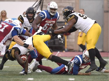 Alouettes quarterback Johnny Manziel (2) makes a tackle after his second CFL pass is intercepted by Ticats linebacker Larry Dean.