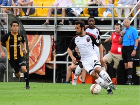 Cristian Portilla  tries to dribble the ball away from Kotaro Higashi (25) of the Charleston Battery during a Fury FC game on May 19. Charleston Battery photo