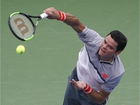 Milos Raonic serves to Novak Djokovic during a Friday quarterfinal of the Western & Southern Open tennis event at Cincinnati.