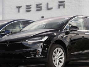 Electric car maker Tesla Motors Canada ULC is suing the Ontario government, claiming it has been treated unfairly in the government's decision to cancel an electric vehicle rebate. A 2018 Model X sits on display outside a Tesla showroom in Littleton, Colo., on July 8, 2018.