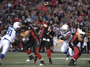 Ottawa Redblacks quarterback Trevor Harris (7) throws the ball during first half CFL action against the Montreal Alouettes, in Ottawa on Saturday, Aug. 11, 2018.