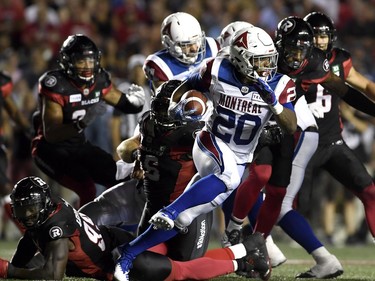 Alouettes tailback Tyrell Sutton tries to break away from the Redblacks defence in the first half.