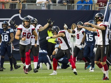 The Ottawa Redblacks defensive line celebrate after stopping the Toronto Argonauts during first quarter CFL action in Toronto on Thursday, August, 2, 2018.