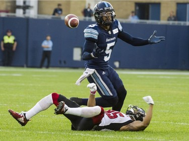 Toronto Argonauts defensive back Jermaine Gabriel (5) and Ottawa Redblacks wide receiver Diontae Spencer (85) look for the ball during third quarter CFL action in Toronto on Thursday, August, 2, 2018.