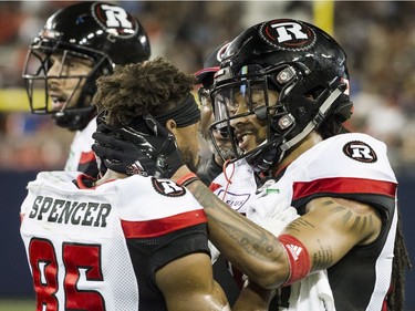 Ottawa Redblacks defensive back Sherrod Baltimore (27) congratulates wide receiver Diontae Spencer (85) after Spencer scored a touchdown during third quarter CFL action against the Toronto Argonauts in Toronto on Thursday, August, 2, 2018.