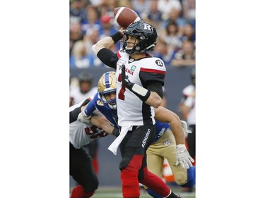 Redblacks quarterback Trevor Harris (7) throws a pass against the Bombers during the first half.