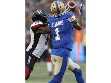 Redblacks cornerback Jonathan Rose (9) can't stop this pass from reaching the hands of Blue Bombers receiver Darvin Adams for a first-half touchdown.