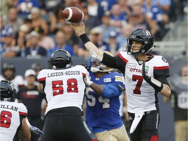 Redblacks quarterback Trevor Harris throws a pass during the first half of Friday's game against the Blue Bombers.