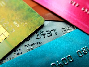 Stack of multicolored credit cards close-up view with selective focus.