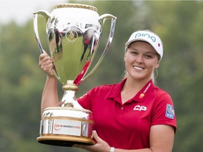 Brooke Henderson of Smiths Falls hoists the trophy after winning the CP Women's Open in Regina on Sunday, Aug. 26, 2018.