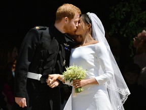 In this Saturday, May 19, 2018 file photo, Britain's Prince Harry and Meghan Markle leave after their wedding ceremony at St. George's Chapel in Windsor Castle in Windsor, near London, England.