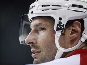 Calgary Flames' Troy Brouwer watches a drill during a team practice in Calgary on April 10, 2017. The Calgary Flames have placed assistant captain Troy Brouwer on unconditional waivers with the intention of buying out the remaining two years of his contract.The move was announced by the team Thursday and will save the Flames $3 million in space under the salary cap in each of the next two seasons.