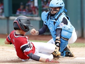 Puerto Rico catcher John Lopez tags out Canada's Cole Balkovec in a 9-4 win over the Little Leaguers from Whalley on Wednesday in South Williamsport, Pa.