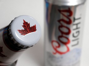 Products from the Mondelez International family of brands, Molson beer, left, and Coors Light beer rest together, in Walpole, Mass. on Nov. 28, 2017. (Steven Senne/The Canadian Press)