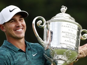 Brooks Koepka holds the Wanamaker Trophy after he won the PGA Championship golf tournament at Bellerive Country Club, Sunday, Aug. 12, 2018, in St. Louis.