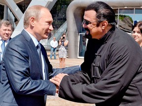 In this Sept. 4, 2015 file photo, Russian President Vladimir Putin, left, and U.S. actor Steven Seagal shake hands after visiting an oceanarium built on Russky Island, in the Russian Far Eastern port of Vladivostok.