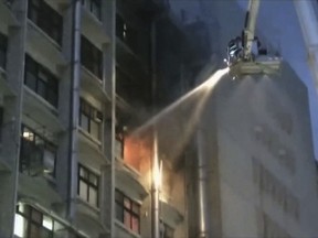 In this image from a video, firefighters try to extinguish fire at Taipei Hospital of the Ministry of Health and Welfare in New Taipei City, Taiwan Monday, Aug. 13, 2018. The fire broke out in the early hours of Monday morning, killing several people. (EBC via AP)