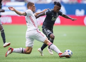 Toronto FC's Nick Hagglund (left) defends against Vancouver Whitecaps' Yordy Reyna during the first half of the first leg of the Canadian Championship final in Vancouver on Wednesday night. THE CANADIAN PRESS