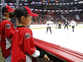 Hyera, 5, watches the Ottawa Senators' practice that was part of the annual Fan Fest at Canadian Tire Centre on Sunday. Patrick Doyle/Postmedia