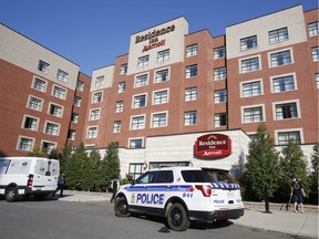 An Ottawa police vehicle is parked in front of the Residence Inn by Marriott hotel on Walkley Road on Sunday morning. Patrick Doyle/Postmedia